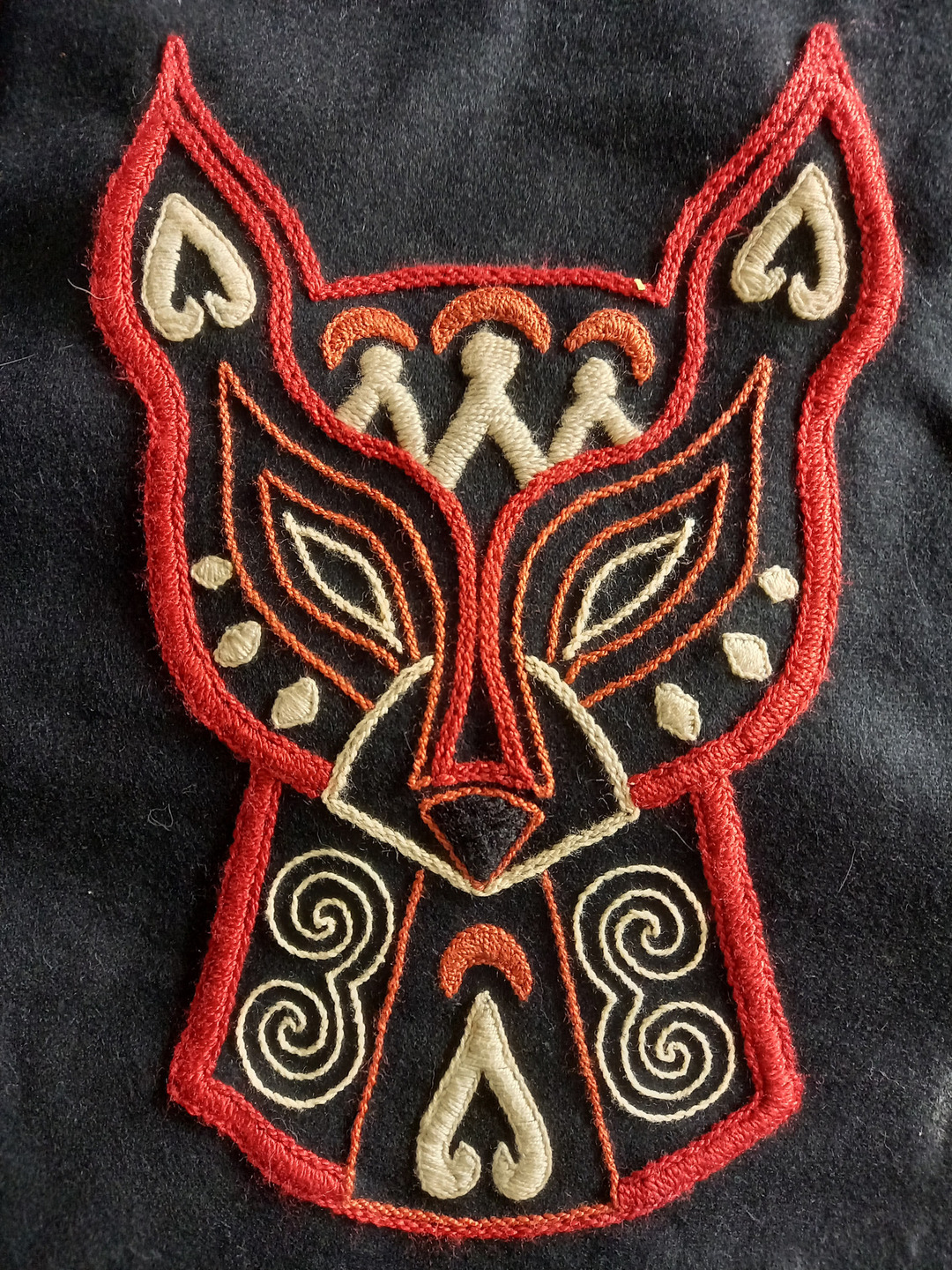 A close up on the fox head motif on the back of the traditional Nanai coat..